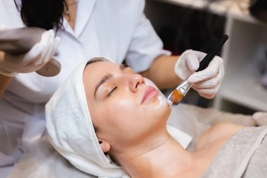 Dermaplaning facial preparation — gentle white mask applied to client